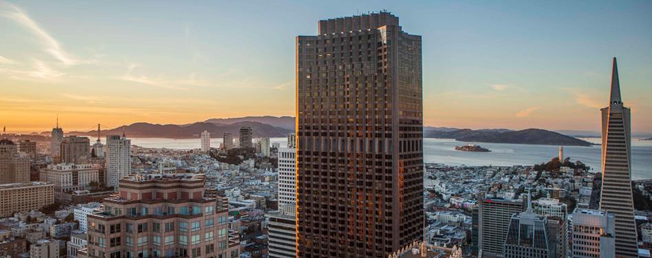 An office tower against a twilight skyline.