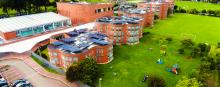 A curved school building against a natural setting.